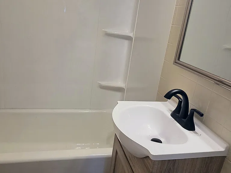 Bathroom with tub/shower combo, new toilet and vanity