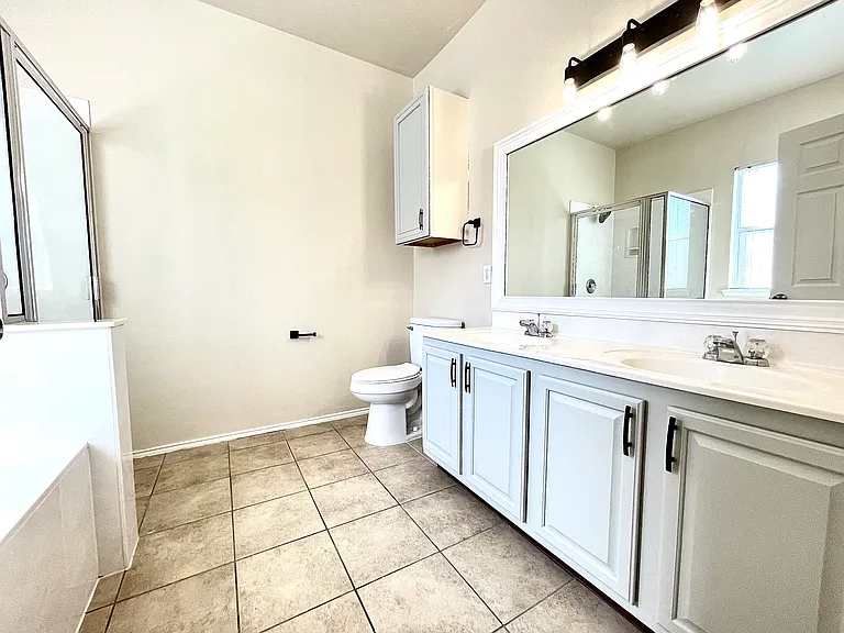 Master bath with a double vanity, garden tub and a shower