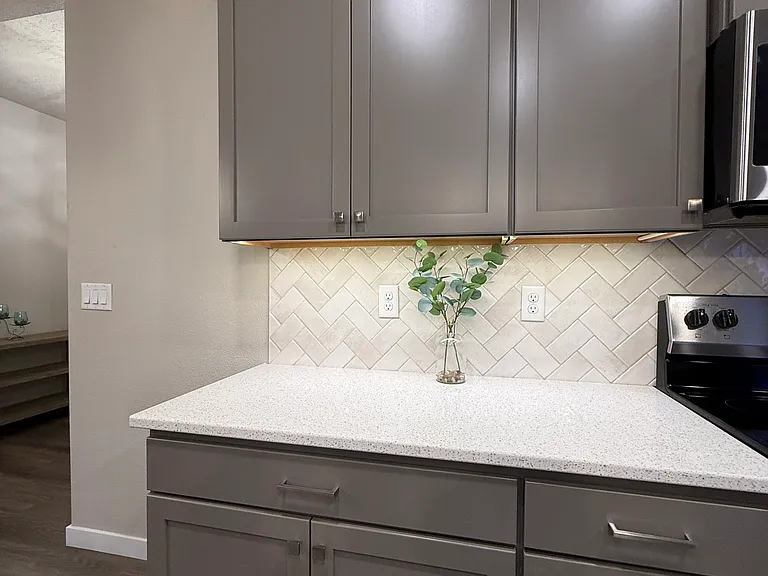 Ample cabinetry with under-cabinet lighting.