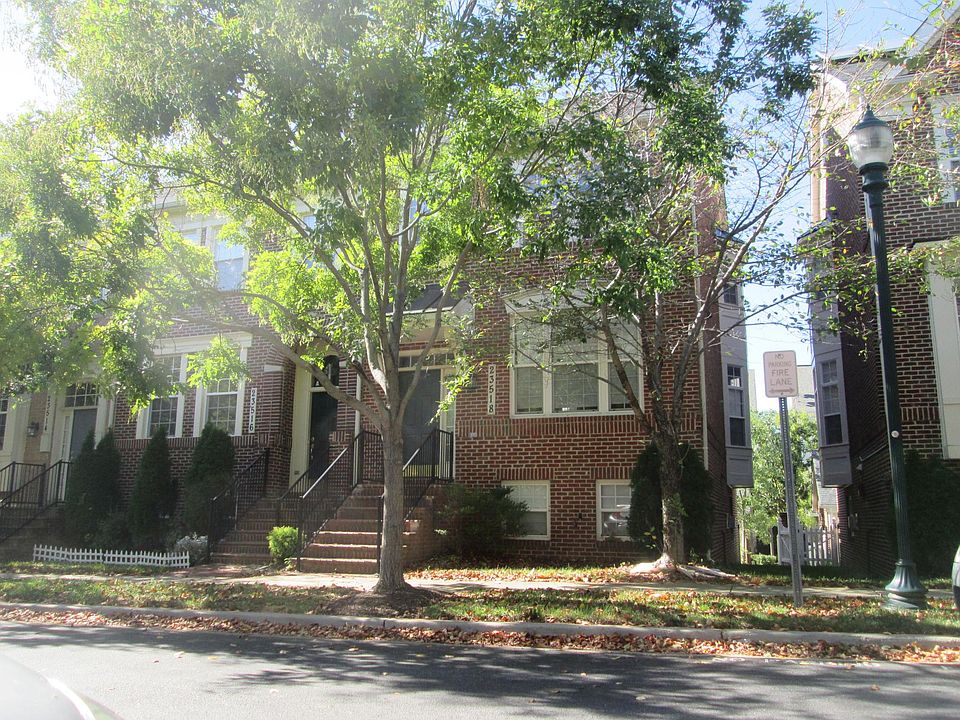 End unit with brick front and side, and side bay windows on two floors