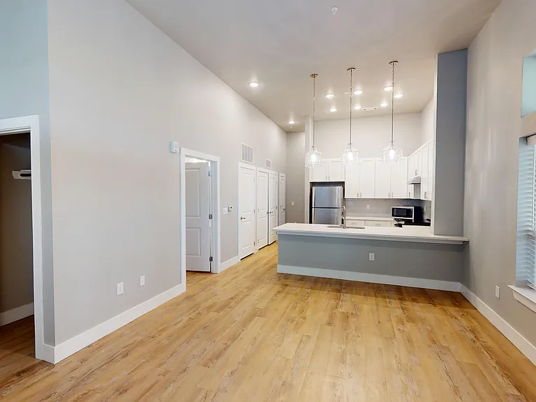 The Bellview floor plan features an open-concept living room and kitchen with pendant lighting and breakfast bar. The Bellview floor plan features an open-concept living room and kitchen with pendant lighting and breakfast bar.