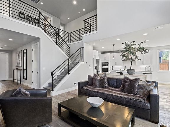 Admire the wood stairs and extensive railings under huge vaulted ceilings.    