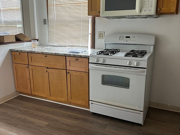 Kitchen with gas stove, microwave