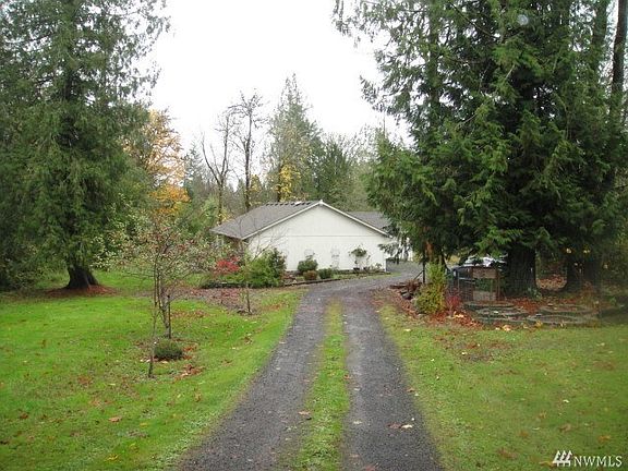 The driveway leading into the home.  I'm a few feet in from Hillcrest Drive.  There is a garden area in the forefront right.