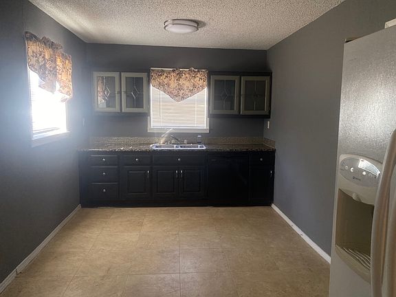 Large spacious kitchen with room for a second small table. washer and dryer in this room along with side by side refrigerator.