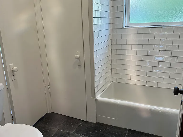 Main floor bath with bathtub and shower.