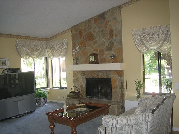 Fireplace windows overlook the cabana, pool and hot tub