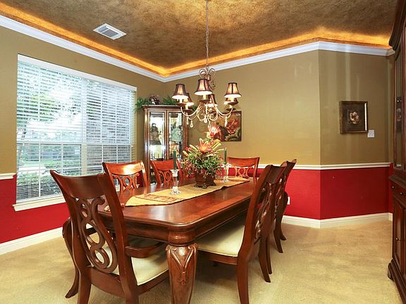 The dining room with cove lighting is the perfect ambiance for dinner parties and dining table worthy holiday meals.