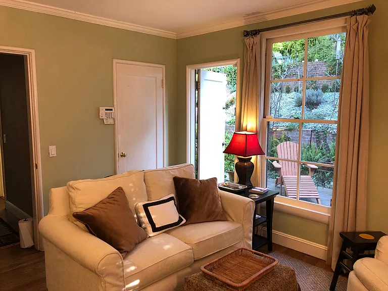 Living Room looking through front window to patio and garden. Please feel free to pick rosemary for cooking and flowers for the table!