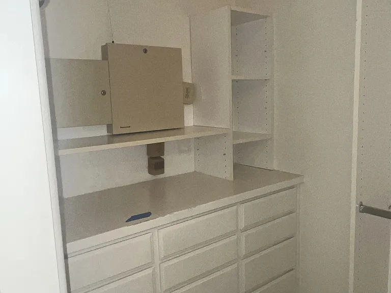 Primary bedroom walk in closet