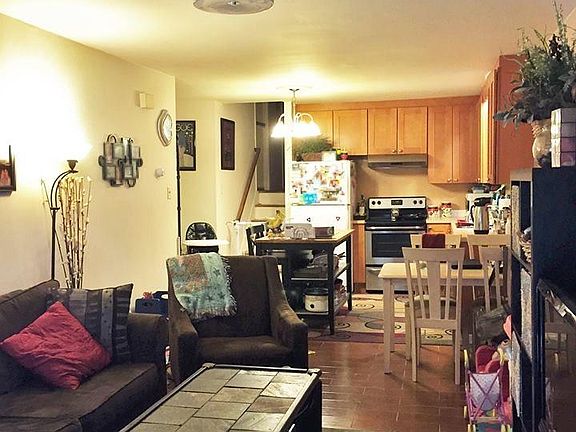 Living Room and Kitchen (open layout) with stairs leading to