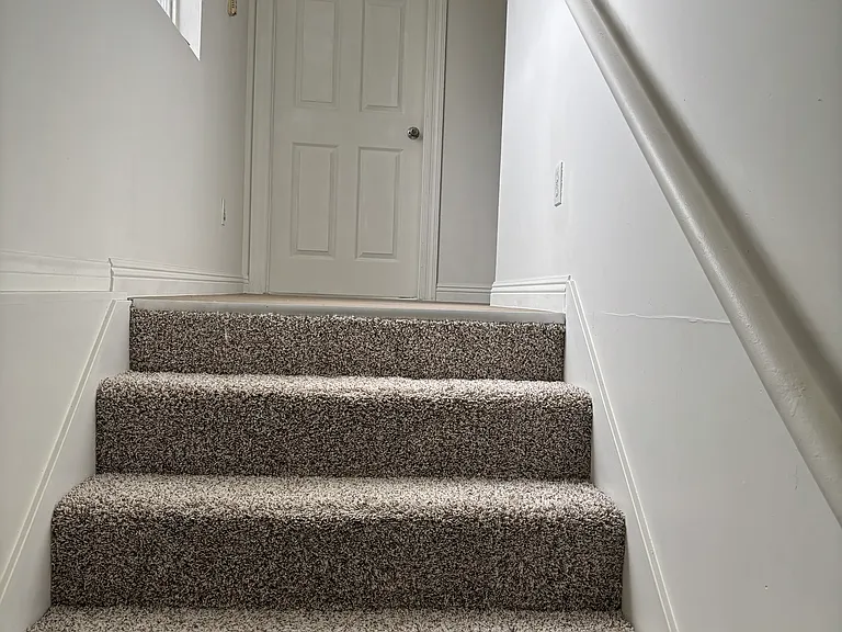 Tops of stairs leading to the first bedroom