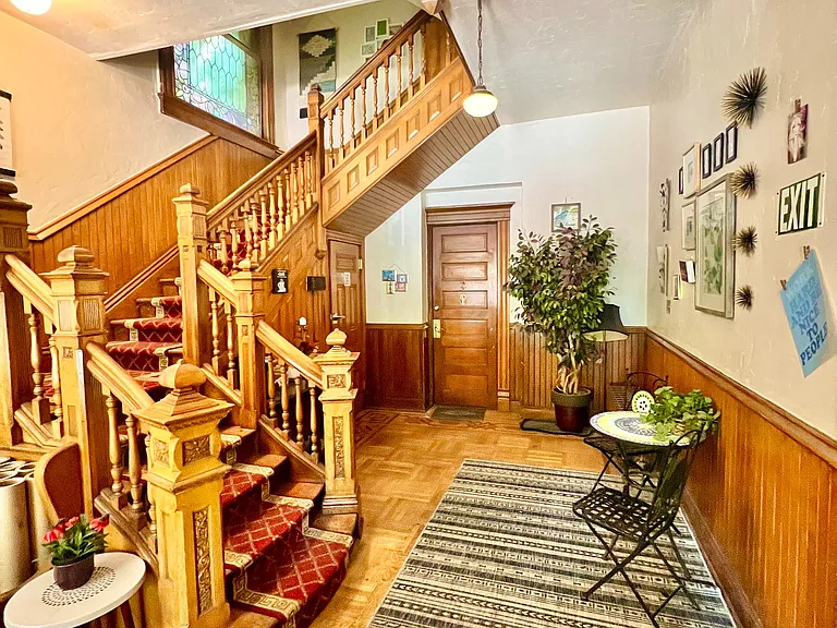 Step into timeless elegance with this beautifully crafted wooden staircase and inviting seating nook.