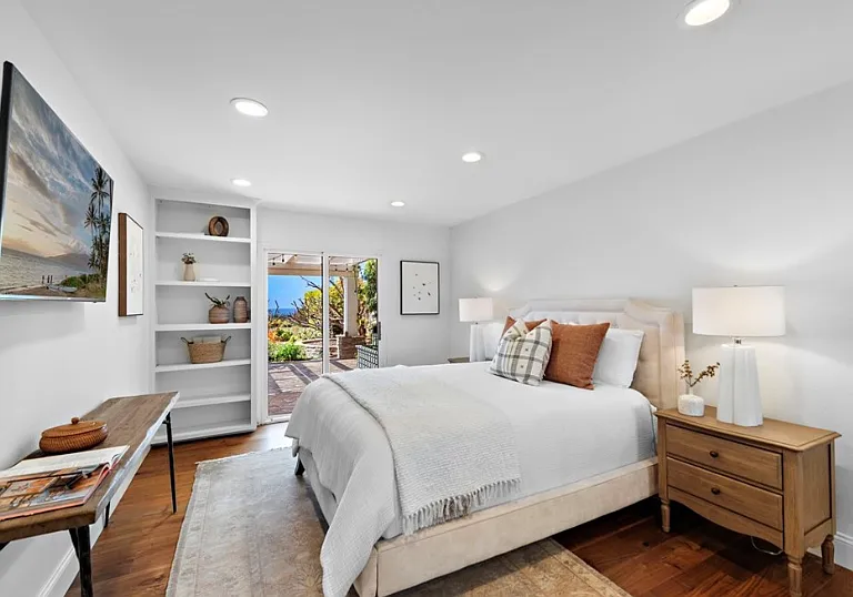 Spacious downstairs bedroom with ocean views and direct access to the backyard patio.