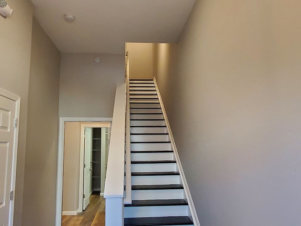 Apartment is on first floor with entrance down the hall past the stairs.