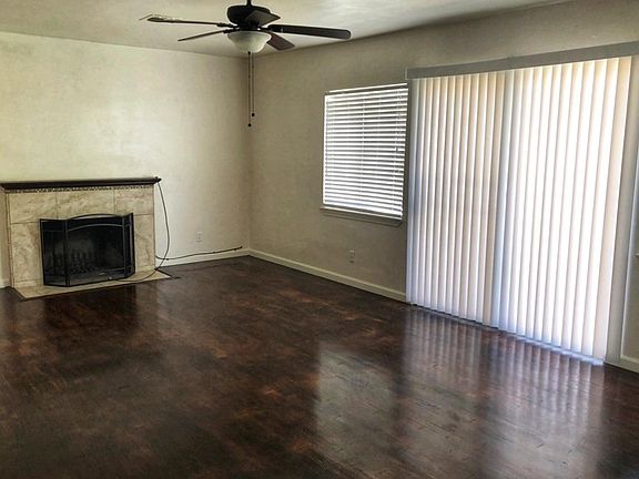 Living room. Original wooden floors and a fireplace. Sliding door gives access to the backyard.