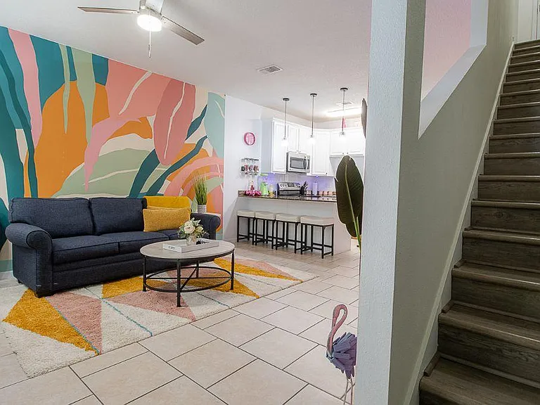Enjoy this tropical vibrant living room infused with energy, personality, and a lively atmosphere.