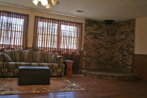 View of living area showing brick hearth.