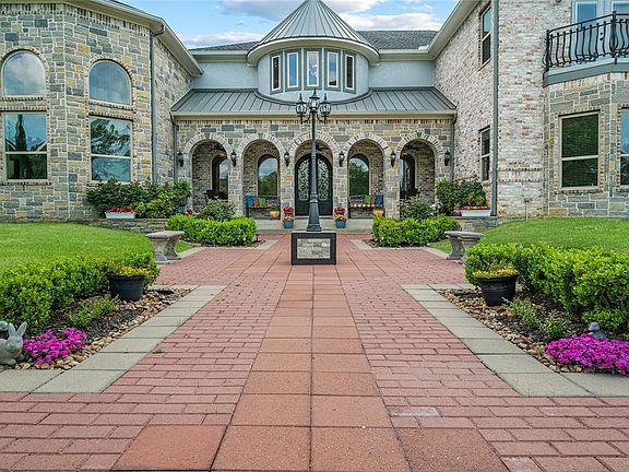 Surrounded by lush landscaping, the entry to this home is luxurious, yet completely welcoming.