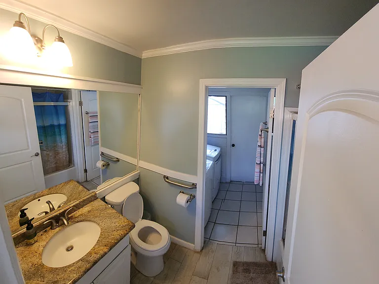 Bathroom 1 of 4 with adjoining laundry room.