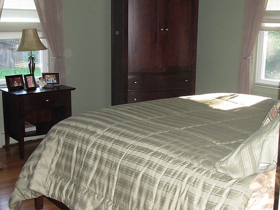 Master Bedroom with custom blinds and hardwood floors