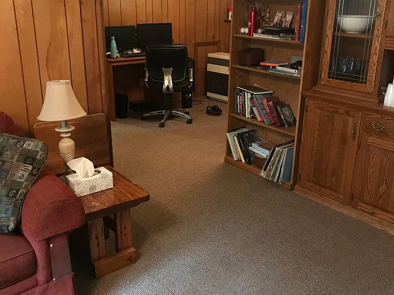 Another angle of family room. Shows space for home office and monitor heating system (capable of heating the whole house).