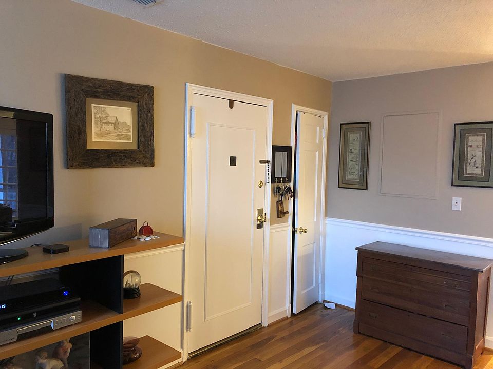 Front door and coat closet (Elfa shelving) with tons of storage space.