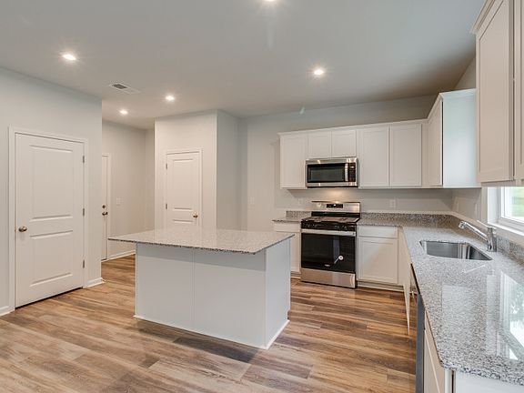 Package A Kitchen with beautiful white cabinets and granite countertops.