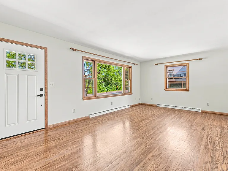 Large Living Room with abundant windows and tranquil sunset views over Lake St. Joe! (19 x 12)