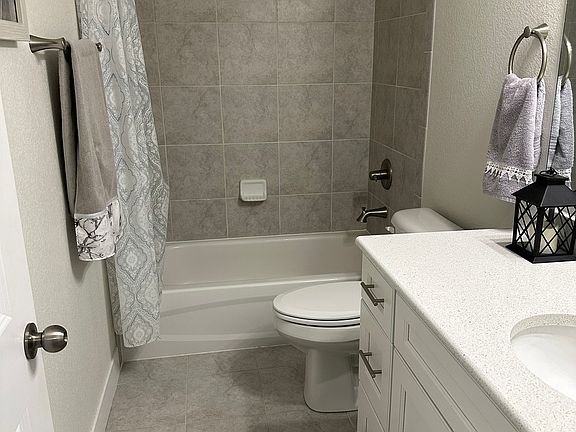 Tiled bathroom with quartz countertops