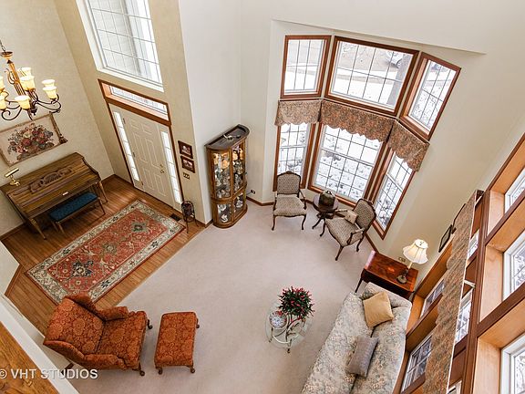 2 story living room drenched in sunlight. View of living room from large loft