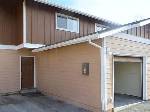 Townhouse style apartment with attached garage space and pri