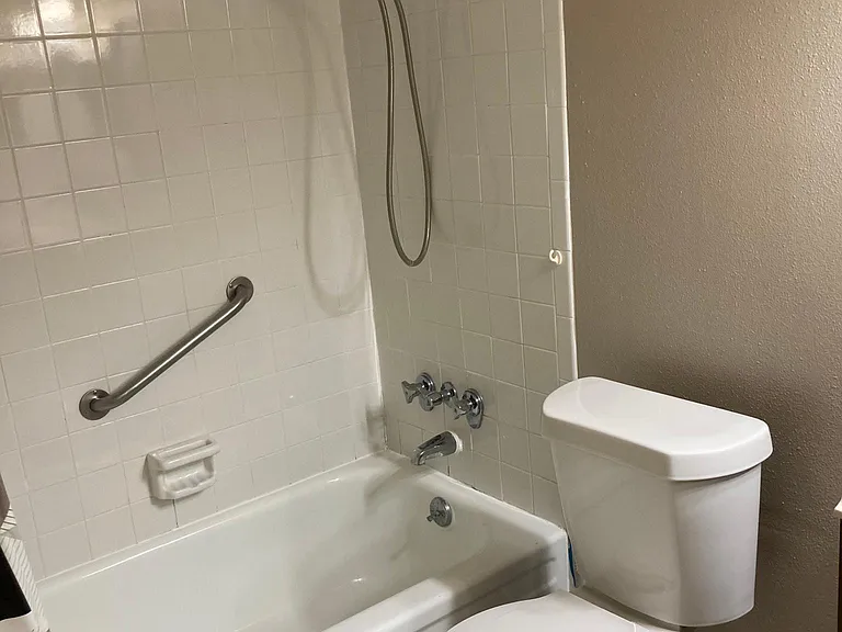 Private full bathroom with tub and shower combination, conveniently located within the primary suite for added comfort and privacy.