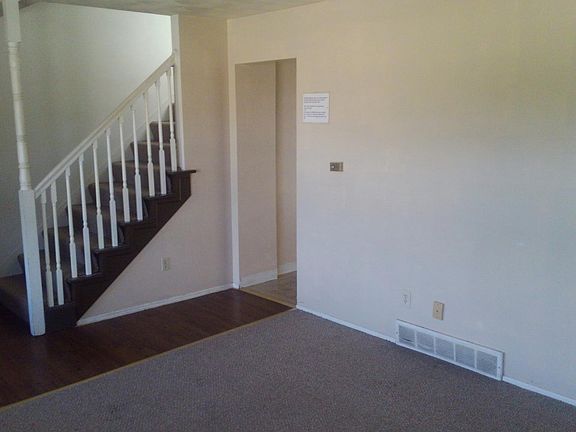 Living room stairwell leading up stairs