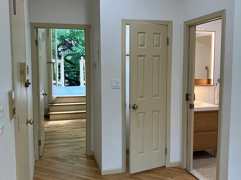 View from the living room to the steps in the bedroom to the deck outside