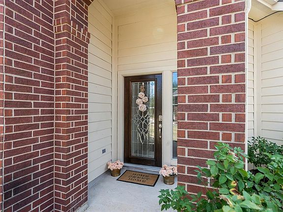 A traditional brick exterior with accent shutters leads you to this charming front porch!