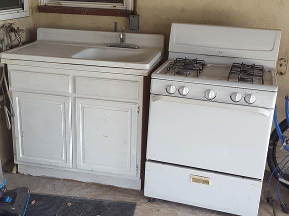 Outdoor kitchen under covered patio.