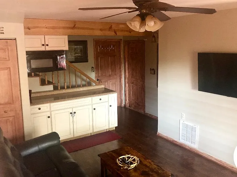 Living room has extra bed & lift top coffee table.