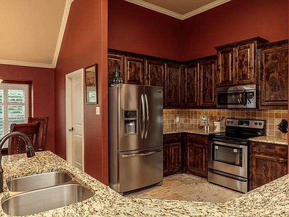 Designer granite countertops with a large food prep area is a welcome addition in any home.