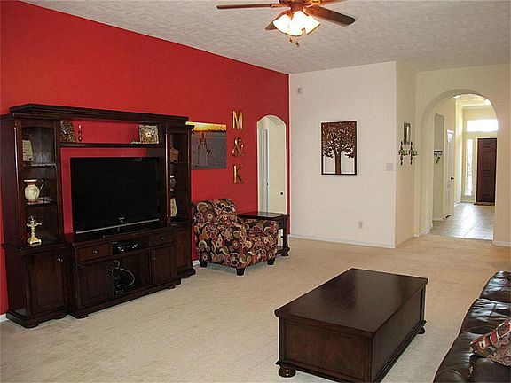 Massive family room/den features neutral carpet and ceiling fan with light fixture!