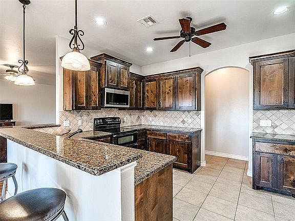 NEW PICTURES COMING!!! Kitchen is currently undergoing a renovation and will have new white cabinets and has new granite, lighting, stainless steel convection oven, and refrigerator with water and ice!