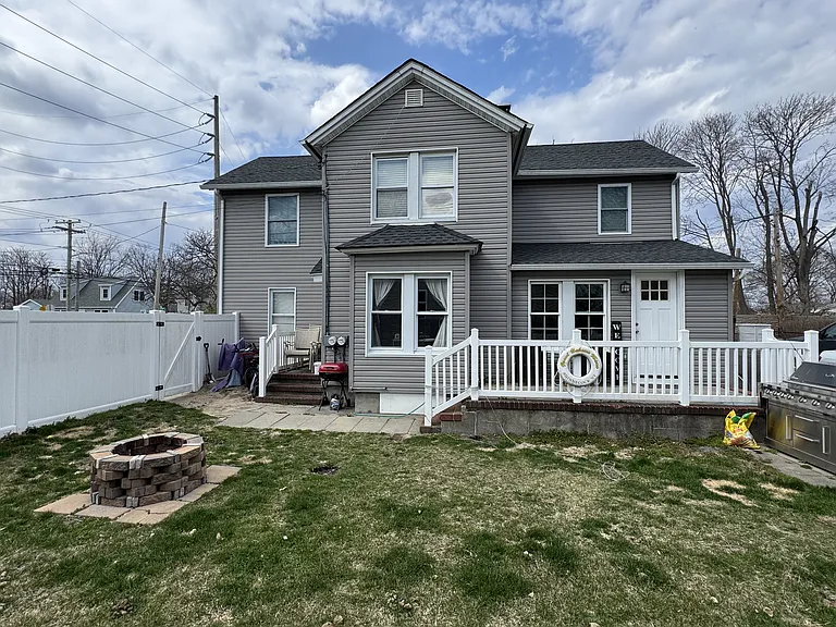 Entrance for unit B with a nice porch, fire pit and BBQ/grass area