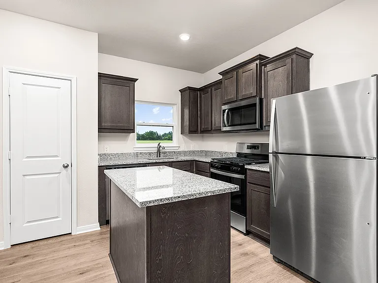 The kitchen has a convenient kitchen isalnd.