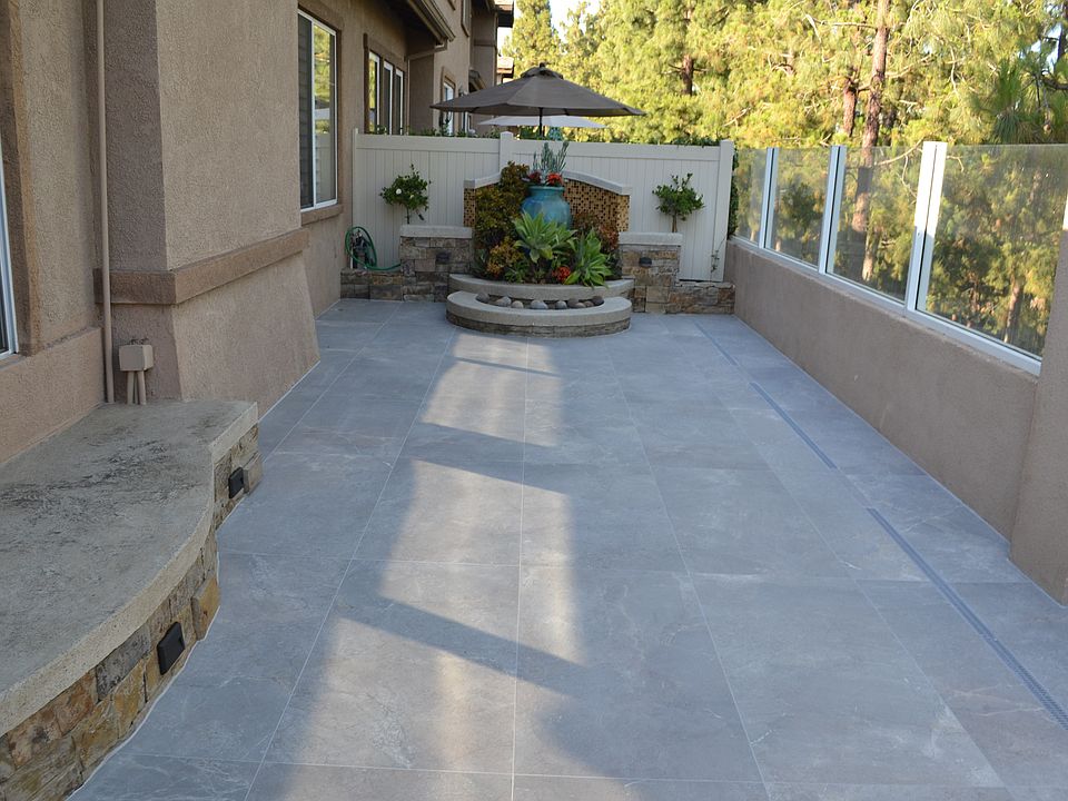 large backyard with brand new tiles and seating area and panoramic view
