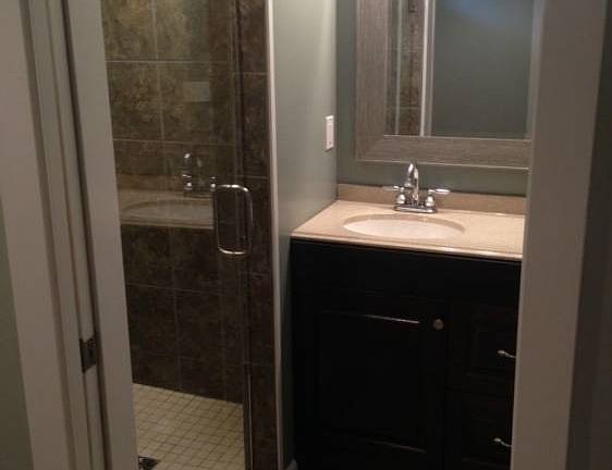 Master bathroom with tiled shower and a high end glass door 