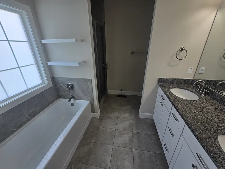 Primary bathroom with tub and separate shower