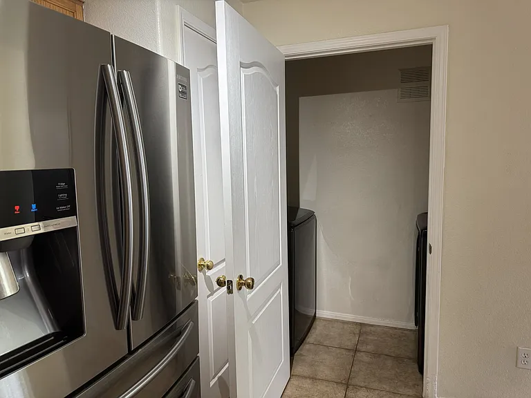 Laundry room next to kitchen.