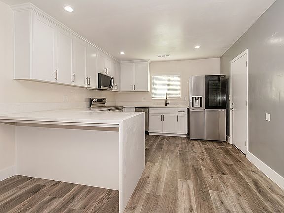 Updated Kitchen with Quartz Counter tops, high end appliances, LVP flooring, custom cabinets to the ceiling with soft close cabinets.