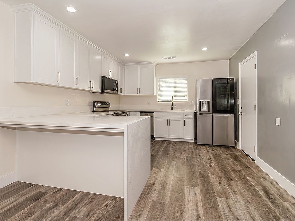 Updated Kitchen with Quartz Counter tops, high end appliances, LVP flooring, custom cabinets to the ceiling with soft close cabinets.
