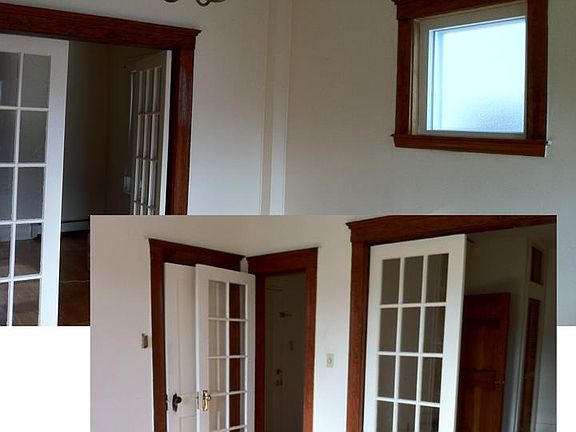 French doors in living room and elegant chandelier. High ce